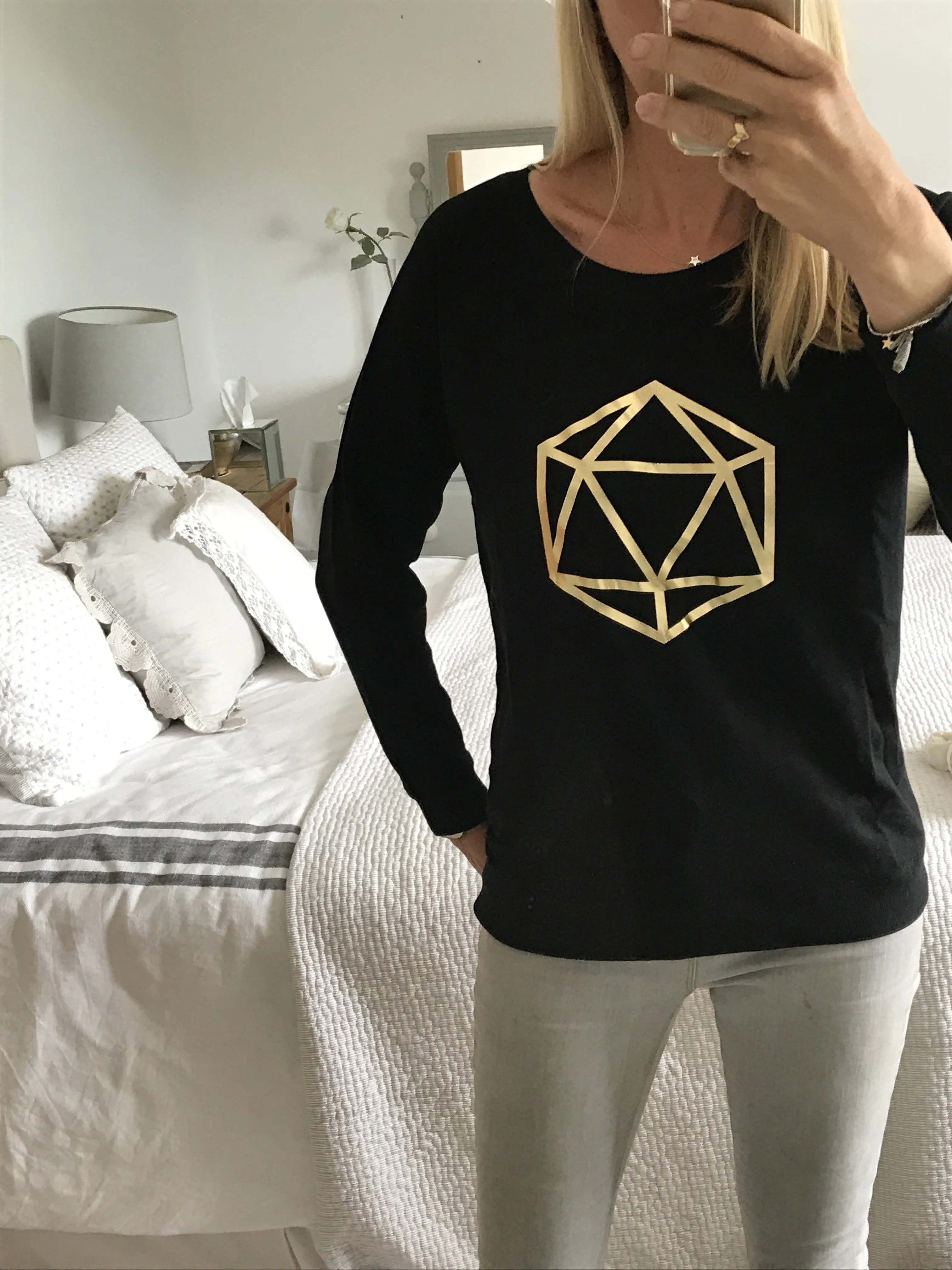 Metallic gold octahedron on black sweat